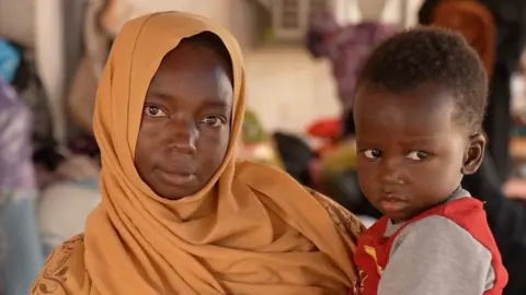 Migrant woman and child in Tripoli, Libya