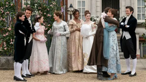 Netflix (L to R) Will Tilston as Gregory Bridgerton, Jonathan Bailey as Anthony Bridgerton, Florence Hunt as Hyacinth Bridgerton, Ruth Gemmell as Lady Violet Bridgerton, Simone Ashley as Kate Sharma, Hannah Dodd as Francesca Bridgerton, Luke Newton as Colin Bridgerton, Claudia Jessie as Eloise Bridgerton, Luke Thompson as Benedict Bridgerton