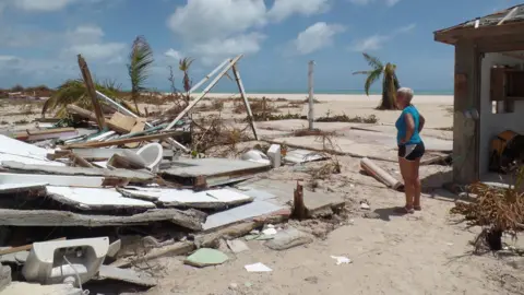 Gemma Handy Sira Berzas surveys the ruins of her Pink Sand Beach bar and restaurant