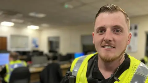 Emma Baugh/BBC Police officer at station