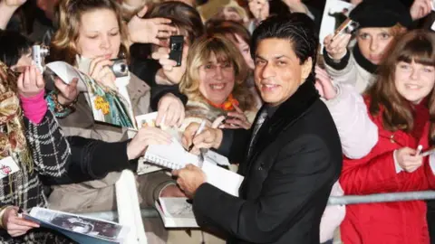 Getty Images Shah Rukh Khan signs autographs for fans as he attends the 'Om Shanti Om' premiere as part of the 58th Berlinale Film Festival at the Berlinale Palast on February 8, 2008 in Berlin, Germany.