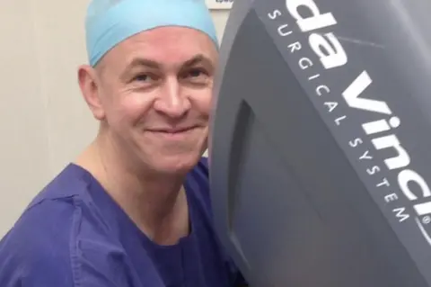 Ken Linton Ken Linton at the controls of a surgical robot