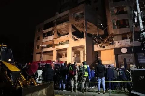 AFP Lebanese emergency responders gather at the site of a strike, reported by Lebanese media to be an Israeli strike targeting a Hamas office, in the southern suburb of Beirut on January 2, 2024.