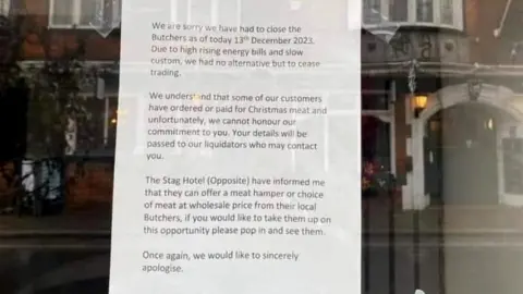 Nicola Cheater sign on window