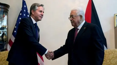 Reuters Antony Blinken shakes hands with Mahmoud Abbas