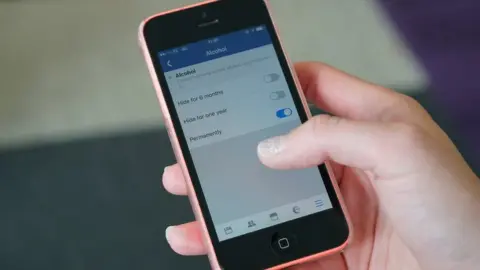 BBC Hand holding mobile phone
