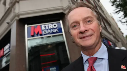 Getty Images Anthony Thomson in 2010 outside a branch of Metro Bank