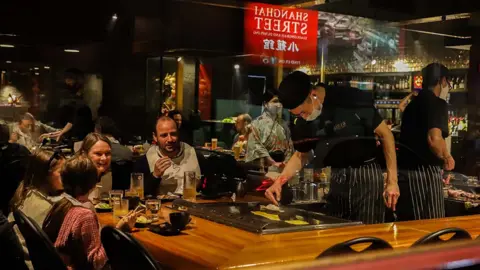 Getty Images Family eat together in doors