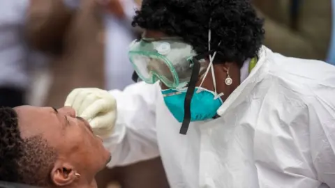 Getty Images The Gauteng government deployed a team of health workers to the Stjwetla informal settlement to test people for COVID-19 on day 5 of National Lockdown on March 31, 2020 in Alexandra, South Africa