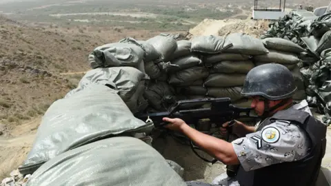 Getty Images A member of the Saudi border guard holds position at a look-out point on the Saudi-Yemeni border