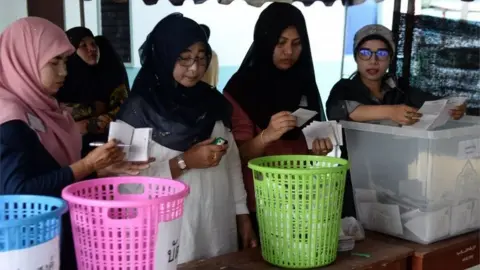 AFP/Getty Images Electoral officials count votes at a polling station in Bangkok on March 24, 2019 after polls closed in Thailand's general election.