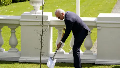 Reuters President Biden planting a tree in Dublin