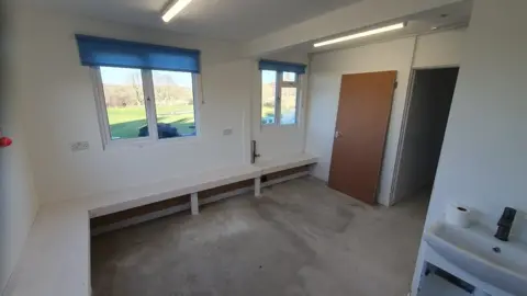 A new room going through building work - benches round the edge, white walls