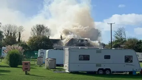Damian Brown Smoke billowing behind Buttyland Caravan Park