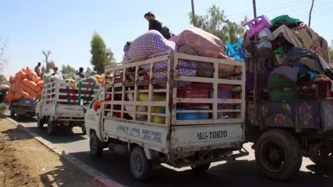 EPA Afghans flee their villages after fighting intensified between Taliban militants and security forces, in Lashkar Gah, the provincial capital of restive Helmand province, Afghanistan, 12 October 2020