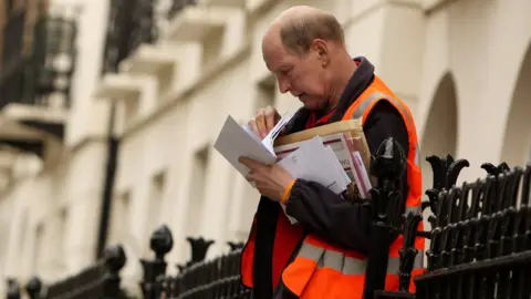 Getty Images A postal worker