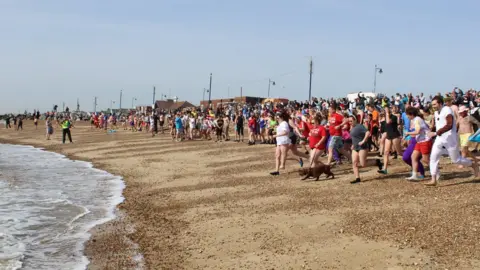 St Elizabeth Hospice People running into the water for the Felixstowe dip