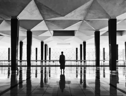 Hanqing Qu A man in a temple in Kuala Lumpur