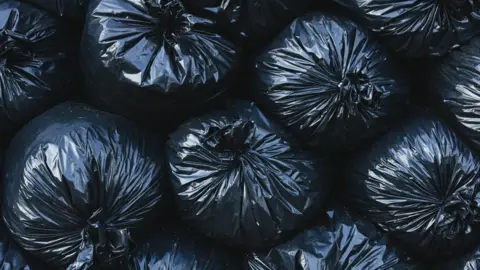 Getty Images Filled bin bags