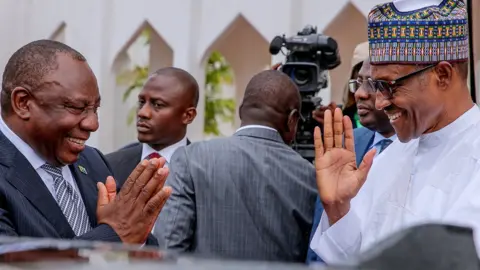 Reuters South African President Cyril Ramaphosa (L) and Nigerian President Muhammadu Buhari (R) greet each other at State House in Abuja, Nigeria - Wednesday 11 July 2018