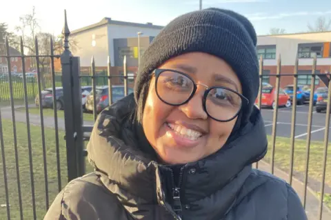 Tom Percival/BBC Dahira Abkey, a teacher on a picket line outside Malcolm Arnold Academy in Northampton