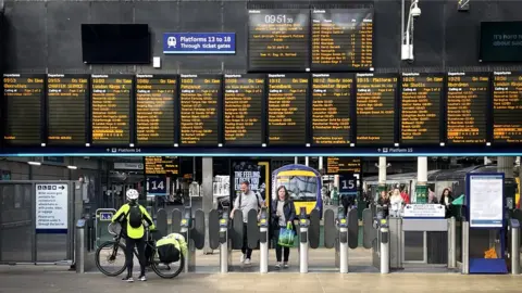 PA Media Commuters and travellers at Edinburgh's Waverley Station