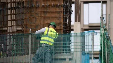 PA Media Construction worker in London