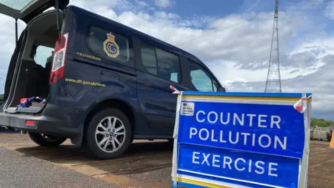 Maritime and Coastguard Agency Counter-pollution exercise sign and MCA van