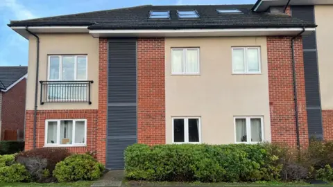 Kate Bradbrook/BBC Two-storey brick and render modern hotel room