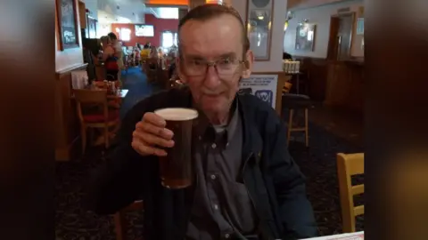 Family photo Huw Evans in a pub with a pint