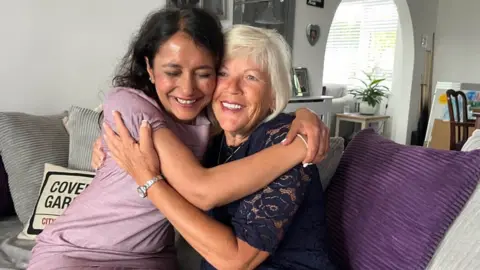 Richard Daniel/BBC Campaigner Melanie Leahy and lawyer Priya Singh embracing in joy