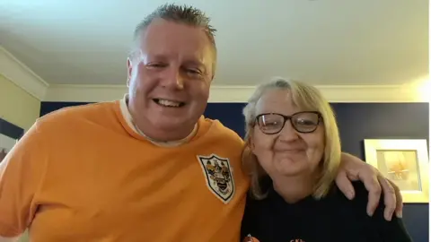 Family photograph Brian Clark and Helen Drewery in Blackpool shirts