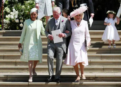 PA Doria Ragland, mother of the bride, the Prince of Wales and the Duchess of Cornwall walk down the steps of St George's Chapel in Windsor Castle after the wedding of Prince Harry and Meghan Markle