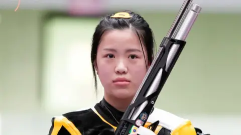 Getty Images Yang Qian of China celebrates after winning the 10m Air Rifle Women's Final on the first day of the Tokyo 2020 Olympic Games