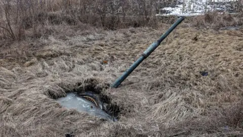 AFP The turret of a destroyed Russian tank pokes out from a swamp in Shandryholove village, Donetsk