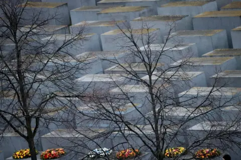 Hannibal Hanschke / Reuters Wreaths are seen at the Holocaust Memorial on the International Holocaust Remembrance Day, in Berlin, Germany, on 27 January 2022