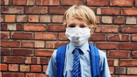 Schoolboy wearing a face covering