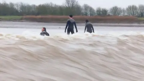 Severn Bore: People surfing on a river