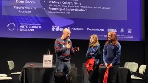 St Marys College Orlaith Henry and Erin Campbell recive esports journalism prize from dom sacco