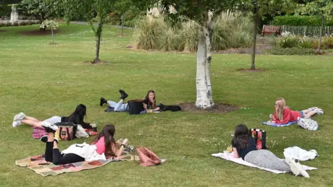 Getty Images People gathering in a socially-distanced manner