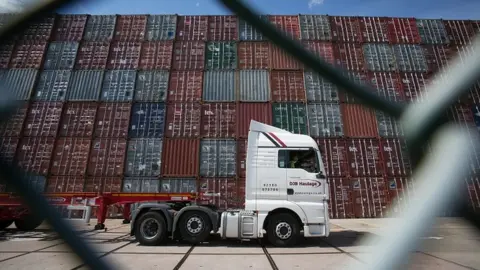 Getty Images Lorry passing shipping containers