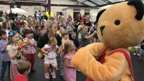 Sooty mascot with children