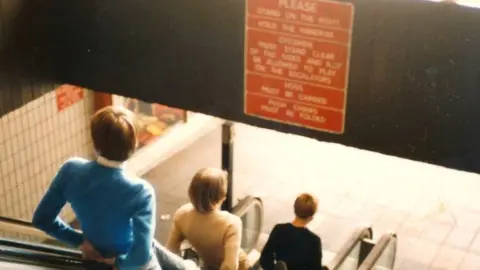 Barnsley Council Boys ride the escalators out of Barnsley Market, 1980s