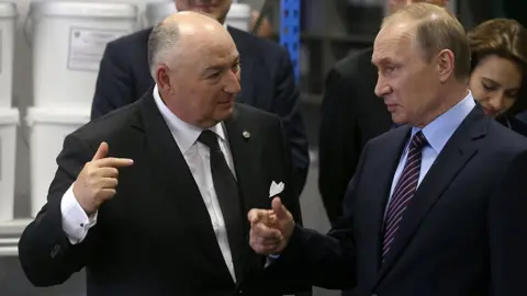 Getty Images Russian President Vladimir Putin (R) talks to billionaire, businessman and owner of Acron Group Viatcheslav Kantor (L) while visiting the Acron plant