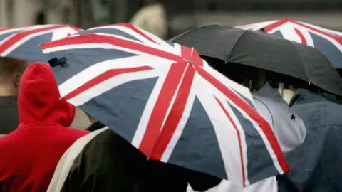 Getty Images People under umbrellas