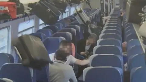 RAIB Luggage falling from overhead racks onto passengers on a train.