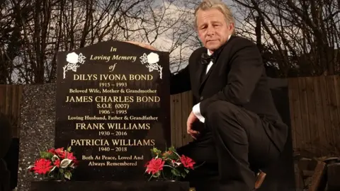 Ron Cant Stephen Phillips standing next to the new gravestone