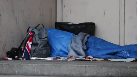 PA Media A homeless person in a sleeping bag on the streets in the UK