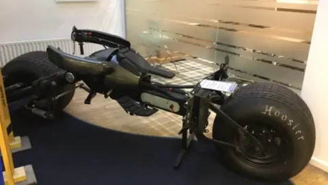 A replica bat bike with chunky motorbike wheels.