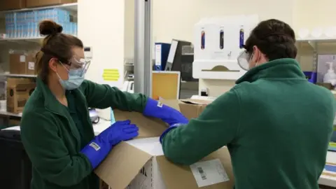 Government of Jersey Lab staff unbox Covid vaccine